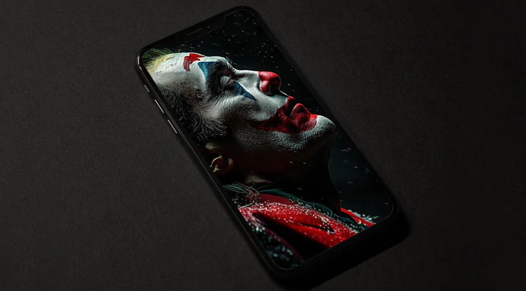 Free Joaquin Phoenix Joker wallpaper 4K in dramatic makeup with snowflakes, available in high-resolution Ultra HD desktop and mobile formats