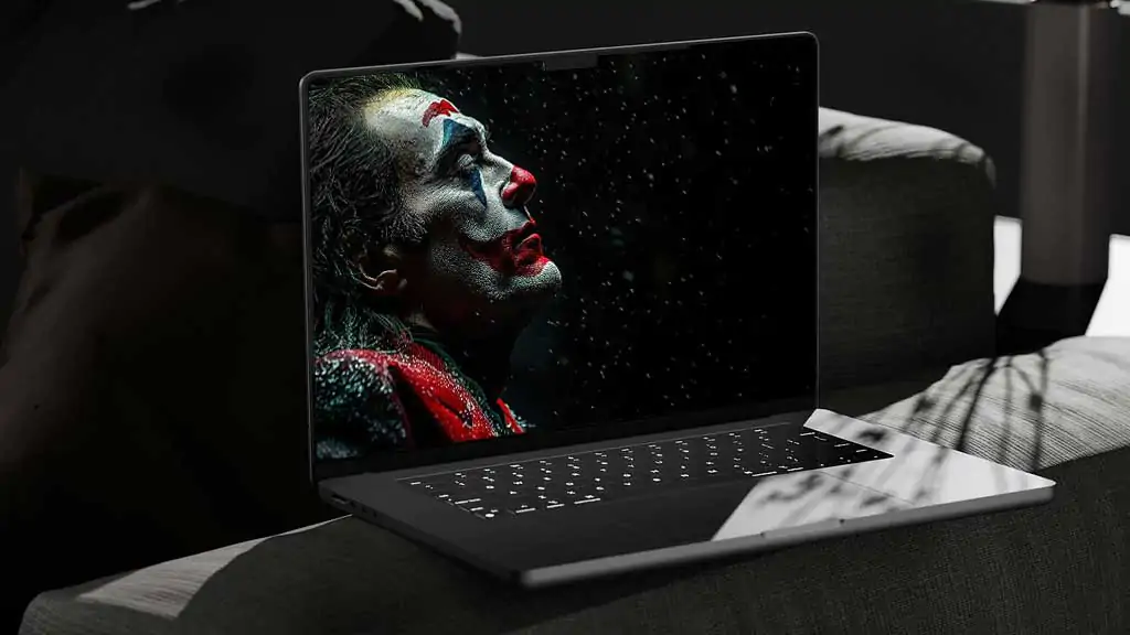 Free Joaquin Phoenix Joker wallpaper 4K in dramatic makeup with snowflakes, available in high-resolution Ultra HD desktop and mobile formats