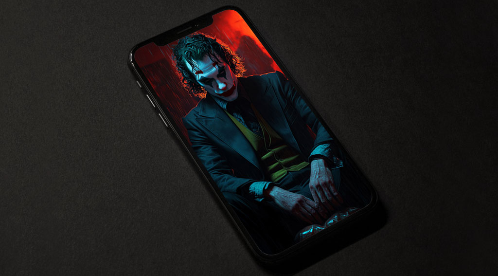 Joker Joaquin Phoenix fond d'écran 4k assis dans une pièce sombre aux tons rouges et bleus, en haute résolution ultrq HD desktop et mobile