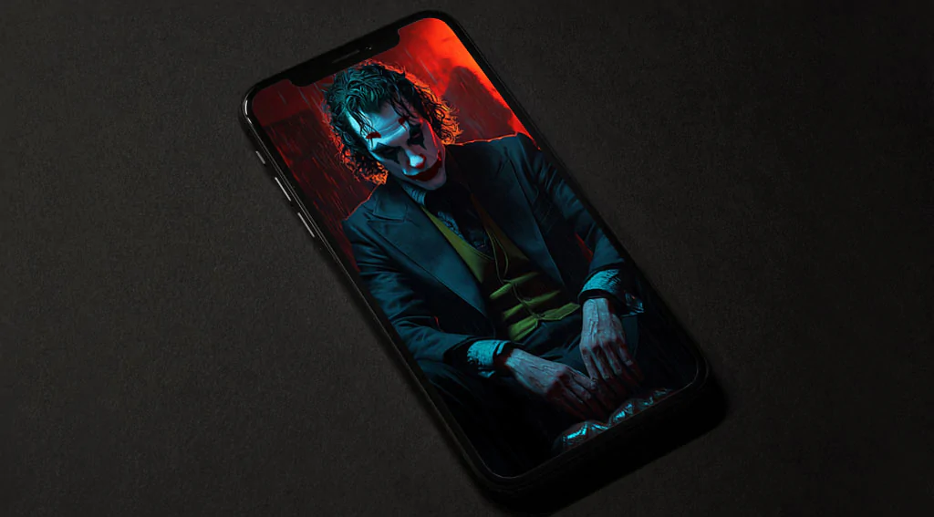 Joker Joaquin Phoenix wallpaper 4k seated in a moody room with red and blue tones, in high-resolution ultrq HD desktop and mobile