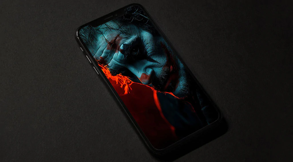 Dramatic Joker profile wallpaper with cyan and red lighting detailed facial features and bokeh background, in HD and 4K