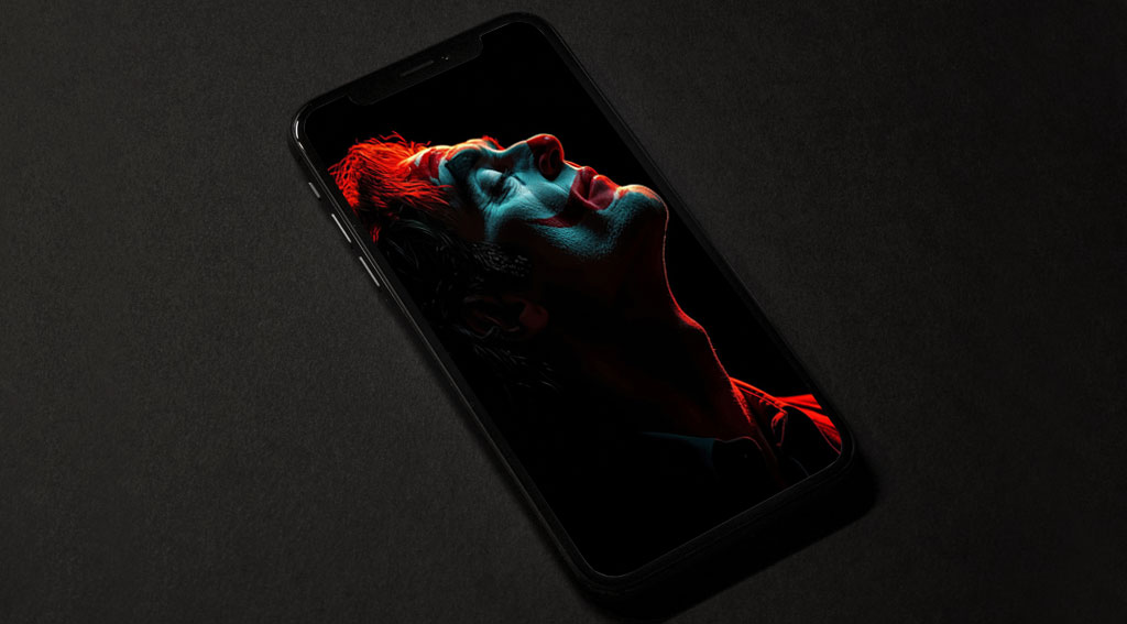 Portrait artistique et dramatique du Joker, fond d'écran 4K avec éclairage rouge sur fond noir, art numérique en haute résolution pour ordinateur et téléphone portable.