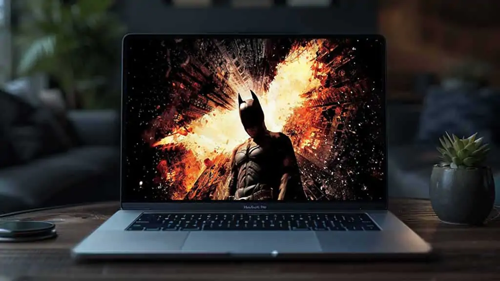 Batman The Dark Knight Rises 4K wallpaper showing hero against exploding Gotham City skyscrapers Ultra HD background Free Download