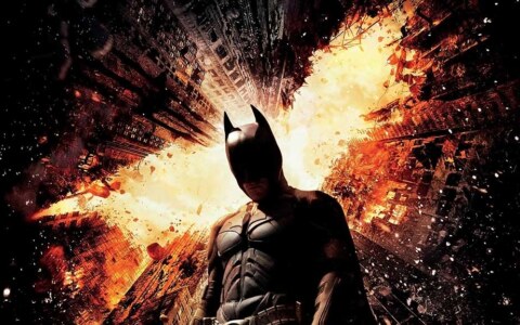Batman The Dark Knight Rises 4K wallpaper showing hero against exploding Gotham City skyscrapers Ultra HD background Free Download