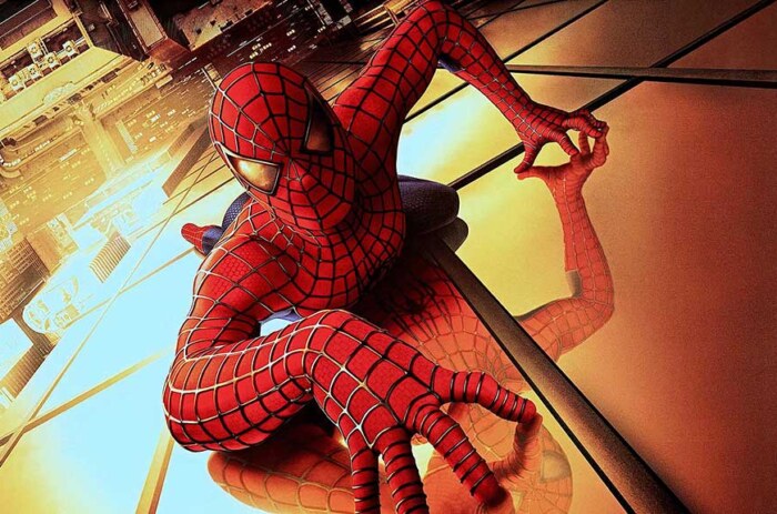 Spider-Man movie 4K wallpaper showing web-slinger swinging through New York City skyscrapers Ultra HD background Free