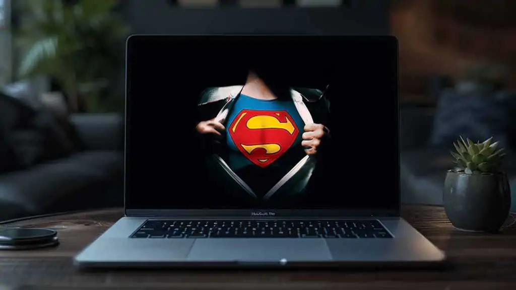 Superman logo reveal 4K wallpaper showing iconic red S shield costume under torn shirt HD superhero background